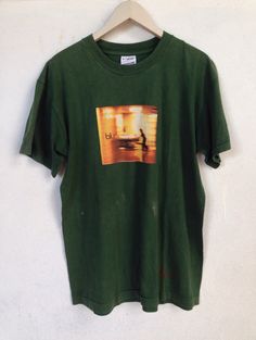 "Rare Vintage Blur britpop band tshirt Made in Ireland SIZE : M (PLEASE CHECK THE MEASUREMENT BELLOW) ARMPIT TO ARMPIT : 20.5\" LENGHT : 29\" CONDITION : Faded color and got paint stand at shirt refer photos (8/10) SHIPPING : I will be ship after received a payment and give tracking numbers. After 7 - 14 Working Days of Shipping from Malaysia please check & give your tracking number parcel to your national post. Receiving the parcel within 7-14 working days. Please contact to me with any que Green Summer Concert Top, 90s Style Screen Print T-shirt, 90s Style Concert T-shirt With Screen Print, Retro Green T-shirt For Streetwear, 90s Short Sleeve Top For Concert, 90s Relaxed Fit T-shirt For Concerts, 90s Style Relaxed Fit T-shirt For Concert, 90s Style Short Sleeve Top For Concert, Green Band Merch T-shirt For Streetwear