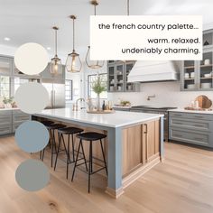 a kitchen with gray cabinets and white counter tops, an island with stools in the center