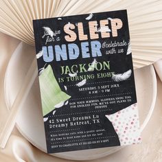 a sleep under the bed birthday party is set up on a plate with napkins