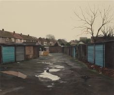 a painting of an empty street with blue garage doors