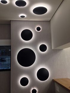 the ceiling is decorated with black and white circles on it's sides, along with recessed lighting