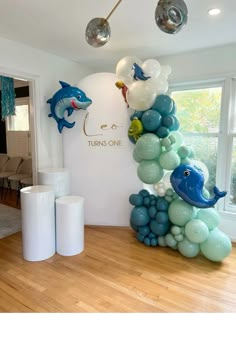 balloons are arranged in the shape of dolphins and dolphins on display at a children's birthday party