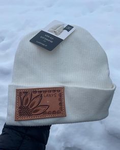 Super soft, warm and nice quality beanie with an adorable tooled hat patch sewn on. Look cute while keeping warm!! Women's size hat one size fits all. Lots of stretch but fits snug on the head.  White in color with tooled leather patch. Handmade Leather Work, Patch Beanie, Hat Patch, Hat Patches, Leather Work, Tooled Leather, Skull Cap Beanie, Leather Patches, Skull Cap