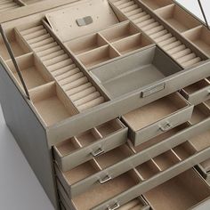 an open drawer is shown with many drawers