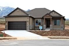 a house is shown in the foreground with mountains in the background