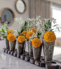 there are many small vases with flowers in them