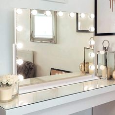 a vanity with a mirror and lights on it