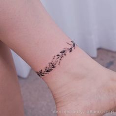 a woman's foot with a small tattoo on the left side of her leg