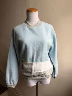 Vintage items make great unique and unexpected gifts. Vintage 80s Sweatshirt | Richard Simmons Workout Top | Retro Baby Blue Sweatshirt | Throwback Willy-Dee Colorblock 80s Gym Top | Campus Top CONDITION: Vintage Excellent MEASUREMENTS: 21" sleeve 19" shoulder to shoulder 22.5" long 39" chest 28" across bottom  LABEL SIZE: M BRAND: Willy-Dee // Made in the USA  FEATURES: Totally retro sweat top with colorblock concept baby blue, gray and white; high v-neck.  Shop VintageBobbieMaude for MORE: https://www.etsy.com/shop/VintageBobbieMaude Retro Crew Neck Sweatshirt For Loungewear, Retro Winter Loungewear Tops, Retro Crew Neck Top For Loungewear, Vintage Crew Neck Tops For Loungewear, Vintage Crew Neck Sweatshirt For Loungewear, Retro Blue Tops For Loungewear, 90s Style Cotton Tops With Ribbed Cuffs, 90s Cotton Tops With Ribbed Cuffs, Vintage Oversized Tops With Ribbed Cuffs