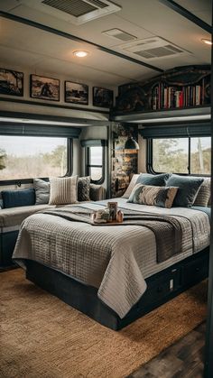 a bed sitting in the middle of a bedroom next to a window with bookshelves