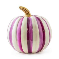 a purple and white striped pumpkin sitting on top of a table