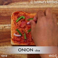 the person is cutting into a piece of bread with peppers and onions on it,