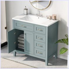 a bathroom vanity with drawers and a mirror above it