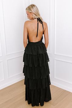 - Step into a stylish dream with this flowy tiered maxi! The halter-tied neckline evokes a sense of effortless grace, while the delicate cutout accent gives it a flirty touch. Perfect for sunlit strolls and moonlit nights, this gorgeous dress will keep you feeling fabulous no matter the occasion. - Fully lined lightweight material - A halter-tied neckline - Pleated detailing as well as a cutout accent at the bodice - An open back - Low back zip closure - A fitted waistline - A flowy tiered silho Tiered Maxi Dress With Tie Back, Tiered Halter Dress For Party, Chic Tiered Maxi Dress For Date Night, Elegant Tiered Maxi Dress With Tie Back, Chic Tiered Skirt Maxi Dress For Date Night, Flowy Tiered Maxi Dress For Date Night, Chic Black Maxi Dress With Tiered Skirt, Black Ruffled Halter Dress For Summer, Chic Black Tiered Skirt Maxi Dress