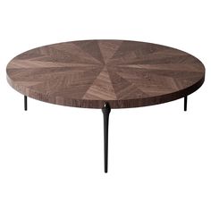 a wooden table with black legs and a circular design on the top, made out of wood