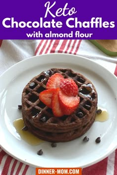 a white plate topped with chocolate waffles and strawberries