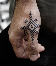 a person with a tattoo on their hand