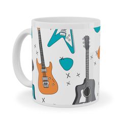 a white coffee mug with guitars and musical instruments on it's side, in front of a white background