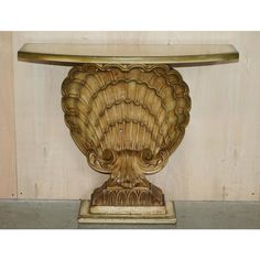 an ornately carved table with a glass top