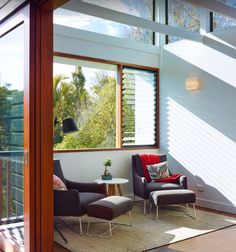 a living room filled with furniture and windows