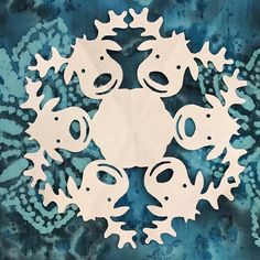 paper cut out of different shapes and sizes in the shape of a wreath with snowflakes on it