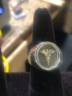 In Excellent Quality. Nice and heavy! Solid Sterling Silver, Stamped MB 925. Caduceus Symbol it self is 14k Solid Gold, not just gold plated. Approx. Weight: 21 gm Top Dimensions: 18x16mm 100% satisfaction Guaranteed. Returns accepted within 30 days. If you are unhappy with your purchase for any reason, please don't rush to give negative feedback, simply place the item back in its original box and send it back to us for a full refund. Thank you IMPORTANT It is highly recommended to confirm your Personalized Yellow Gold Signet Ring Collectible, Silver Jewelry With Certificate Of Authenticity As Gift, Symbolic Silver-colored 14k Gold Signet Ring, Symbolic Silver Signet Ring In 14k Gold, Silver 14k Gold Signet Ring For Commemoration, Symbolic Hallmarked Signet Ring For Commemoration, 14k Gold Jewelry With Certificate Of Authenticity, 14k Gold Round Jewelry With Certificate Of Authenticity, White Gold Rings With Certificate Of Authenticity For Gift