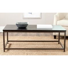 a coffee table sitting on top of a rug