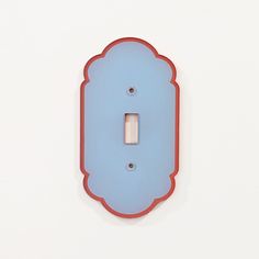 a blue light switch cover with a red frame on the front and back of it