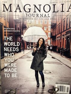 a woman standing in the rain with an umbrella over her head and words on it