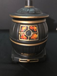 a black and gold vase sitting on top of a table