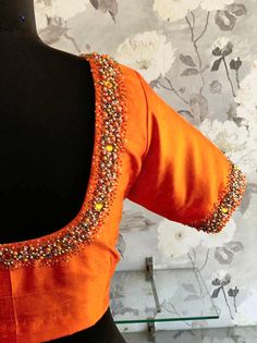 Contemporary orange blouse made in raw silk with multi color bead detailing on the sleeves and neckline Orange Blouses For Women, Orange Color Blouse Designs, Orange Colour Saree Contrast Blouse, Traditional Fitted Hand Embellished Blouse, Designer Embellished Fitted Blouse, Designer Fitted Embellished Blouse, Traditional Fitted Hand-embellished Blouse, Fitted Elegant Orange Blouse, Elegant Fitted Orange Blouse