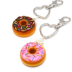 two donuts with sprinkles are hanging from chains