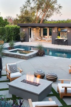 an outdoor patio with fire pit and seating