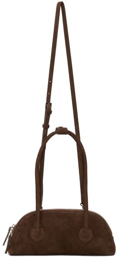 Suede shoulder bag in brown. Detachable shoulder strap with lanyard-clasp fastening. Twin carry handles at top featuring press-stud tab. Logo embossed at face. Zip closure. Leather logo patch at interior. Twill lining in black. Silver-tone hardware. Approx. 10.25 length x 5 height x 1.75 width. Supplier color: Dark brown Marge Sherwood, Leather Logo, Dark Brown Leather, Press Studs, Brown Suede, Luxury Streetwear, Lanyard, Patch Logo, Black Silver