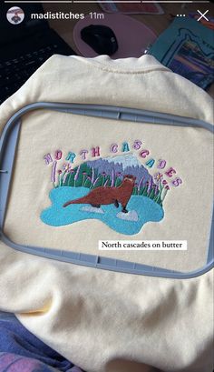 the back of a backpack with an embroidered otter on it's side and words happy birthday, north cascades on butter