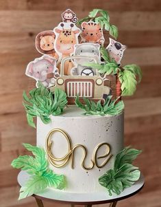 a cake decorated with animals and trees on top