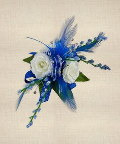 a blue and white corsage with feathers