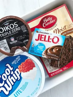 three different flavors of ice cream and chocolate cake in a tray on a white table