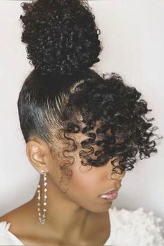 Black Hairstyles Bun Updo, Natural Bun With Bangs Black Women, Curly Bangs And Bun Natural Hair, Natural Black Hair Updo Hairstyles, Curly Ponytail With Two Bangs, Black Natural Hair Updo Hairstyles, Updo Hairstyles On Natural Hair, Natural Hair Curly Ponytail, Afro Bun Hairstyles Updo