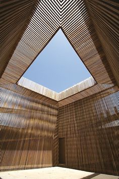 the inside of a building with wooden slats