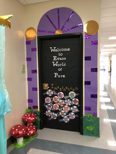 an entrance to the world is decorated in purple and green with lots of balloons around it