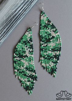 These camouflage beaded earrings are made of high-quality Czech beads and strong synthetic thread. They are elegant, fashionable, and highly versatile, suitable for everyday wear. Features: Sterling silver components Color: beige, green. This item is currently in stock. More beaded earrings http://etsy.me/2ycItdb Gerdan necklaces http://etsy.me/2mihf0J Beaded necklaces http://etsy.me/2Dkf1Fo Crochet necklaces http://etsy.me/2CAPdFc Back to shop https://www.etsy.com/shop/Namystynka Green Beaded Chain Earrings, Camo Earrings, Long Turquoise Earrings, Seed Beads Diy, Turquoise Bead Earrings, Blue Beaded Earrings, Beaded Chandelier Earrings, Bead Earring, Abstract Earrings