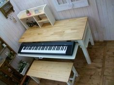 a piano sitting on top of a wooden table