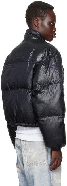 Down-filled and water-repellent quilted nylon ripstop jacket. · Funnel neck · Two-way zip and press-stud closure · Flap pockets · Elasticized hem and cuffs · Zip pocket at interior · Full taffeta lining Supplier color: Black tech Fill: 50% duck down, 50% synthetic Hallofill. Black Functional Puffer Jacket With Padded Collar, Black Functional Puffer Jacket With Double-lined Hood, Black Outdoor Puffer Jacket With Double-lined Hood, Nylon Puffer Jacket With Double-lined Hood, Luxury Nylon Puffer Jacket With Double-lined Hood, Our Legacy, Duck Down, Funnel Neck, Black Crop