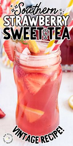 a mason jar filled with strawberries and lemonade on top of a white table