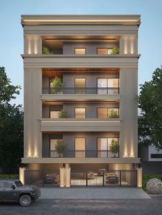 an apartment building with balconies and plants on the balconies is lit up at night