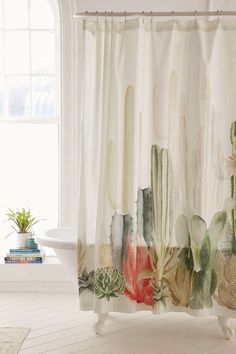 a shower curtain with cactus and succulents on it in front of a window