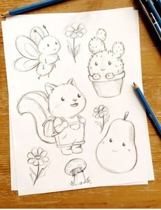 a drawing of some animals and plants on a piece of paper with pencils next to it