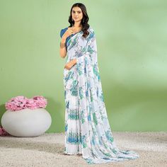 Blue colored saree is made from chiffon fabric which is highlighted with beautiful floral printed work as shown. Comes along with unstitched chiffon blouse piece which you can customise as per your design/style. Occasion - You can wear this saree for casual and daily wear. Note:- the actual product may differ slightly in color and design from the one illustrated in the images when compared with computer or mobile screen. Measurements: Saree : Chiffon : 5.5 Mtrs Blouse : Chiffon : 0.8 Mtr Material: Chiffon Stitch Type: Unstitched Country of Origin: India Care Guide: Dry Clean Elegant Georgette Blouse Piece With Printed Motifs, Festive Georgette Printed Saree, Georgette Pre-draped Saree With Printed Motifs, Printed Georgette Saree For Festive Occasions, Festive Georgette Saree With Printed Details, Printed Georgette Blouse Piece For Saree, Georgette Saree Blouse Piece With Printed Motifs, Chiffon Pre-draped Saree For Navratri, Elegant Georgette Blouse Piece With Digital Print