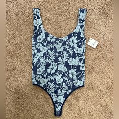 Nwt Free People Blue Floral Bodysuit. Size Xs/S. Sweetheart Neckline In Front With A Scoop Back That Isn’t Super Low, But There Is A Built In Bra For Extra Support! Also Has A Snap Closure At The Bottom. Feel Free To Comment If You Have Any Questions. Willing To Accept Offers Or Bundle For A Discount! Floral Bodysuit, Free People Tops, Sweetheart Neckline, Blue Floral, Snap Closure, Free People, Womens Tops, Feel Free, Bra